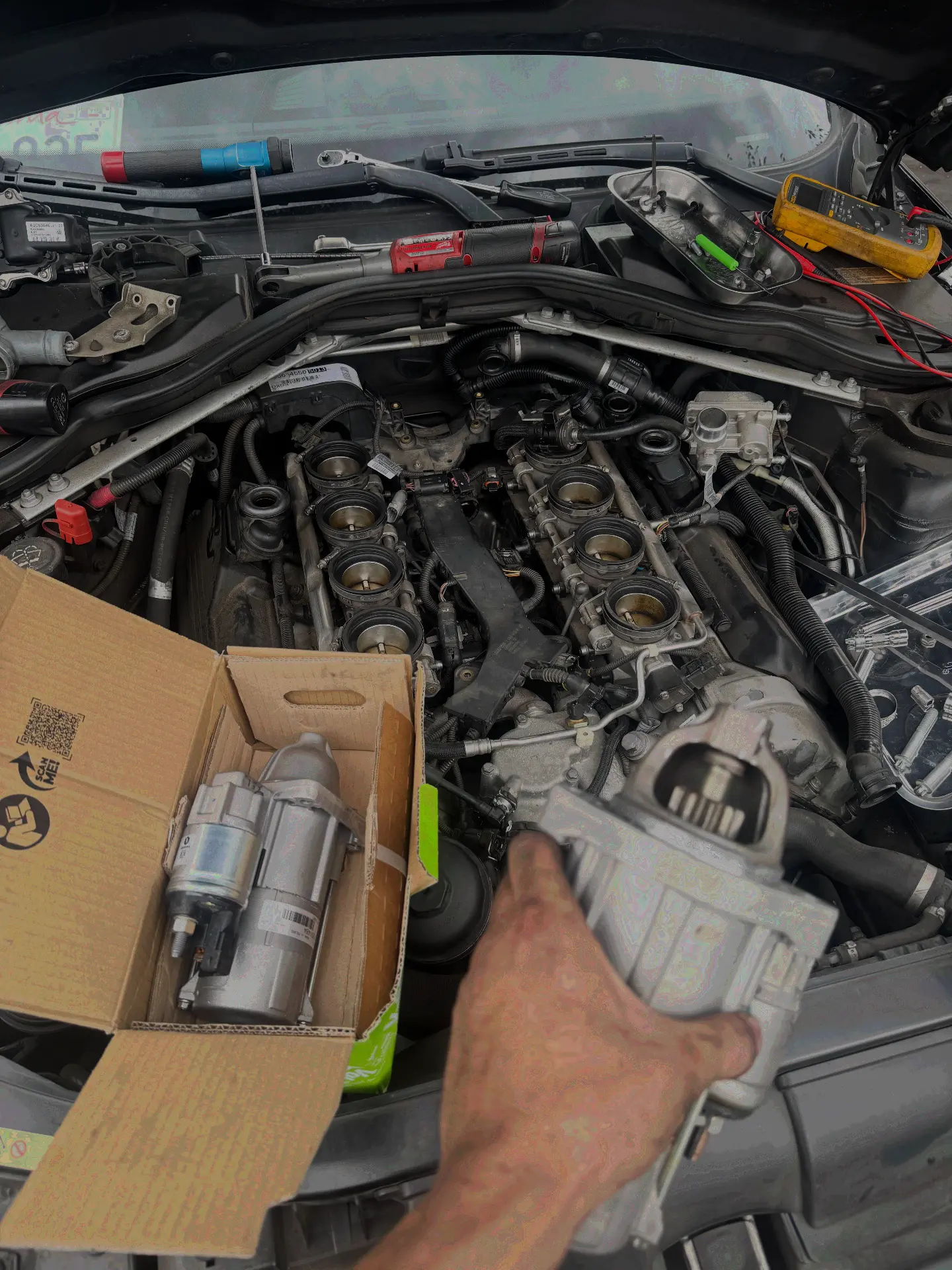 Starter replacement — Intake off for access, new OE starter ready to go in.